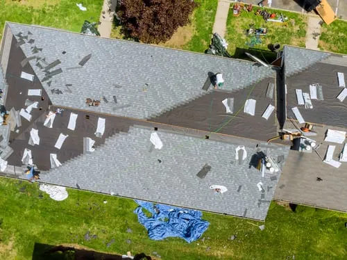 Aerial view of a GJC Roofing crew replacing a residential roof